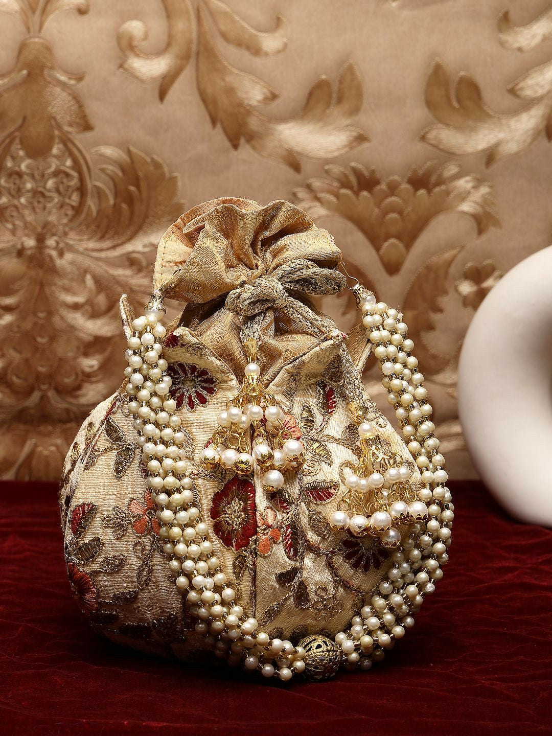 Buy Beige & Gold-Toned Pearl Embellished Potli Bag with Tassels | Indiaista